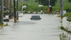 Heavy rain and flooding in north-central Japan strands people and vehicles